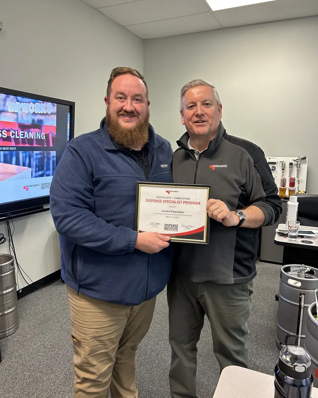 Jordan Patsalides of Draft Line Solutions holding his Micro Matic Dispense Institute Dispense Specialist Program certificate